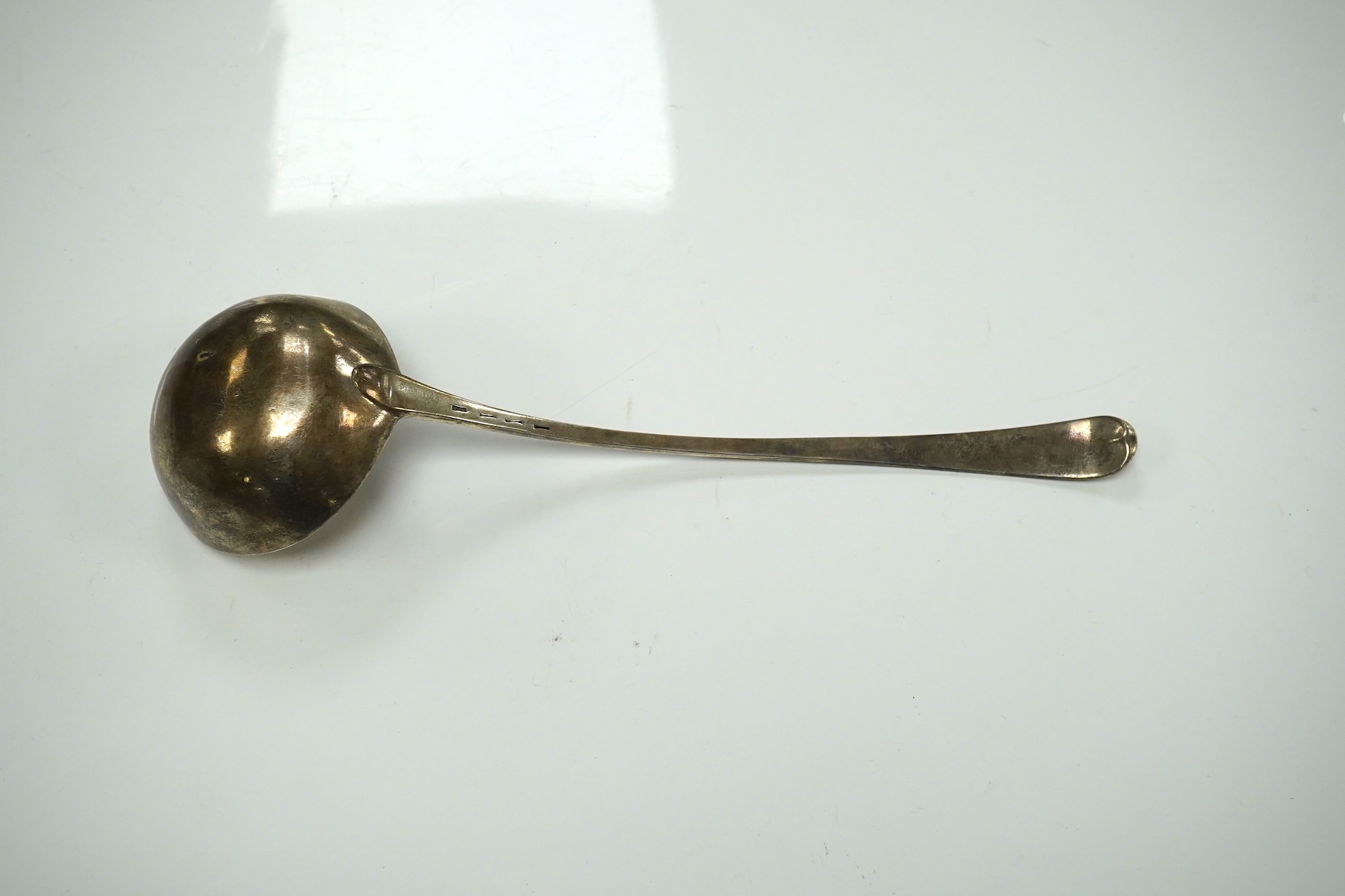 An 18ct century silver Old English pattern soup ladle, pinched marks, 32.8cm, 4.5oz. Condition - poor to fair